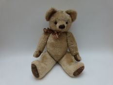 A large blonde mohair Teddy bear with brown leather pads, stitched woollen mouth and nose,
