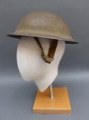 A WWII British military helmet stamped F & L HPP,
