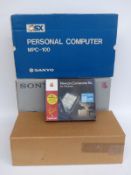 Four vintage computers and accessories comprising Acorn Electrical, Sanyo MSX Personal Computer,