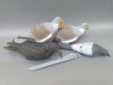 Four pigeon and bird decoys on stands