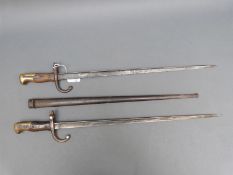 Two Gras M1874 French bayonets, one dated 1883, the other indistinct, one with scabbard.