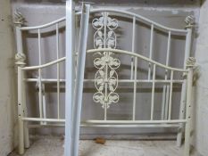 A modern double bed with hollow globe finials