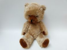 A large blonde mohair Teddy bear with shaved brown pads and snout, stitched woollen mouth and nose,