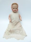 German lacquer doll with open mouth, weighted brown eyes, short brown hair,