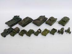 Fourteen Dinky Toys diecast model military vehicles including tanks, guns,