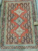 A handmade woollen rug with geometric and repeating pattern,