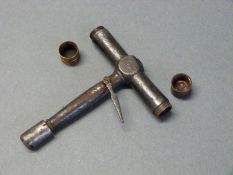 T shaped nipple wrench/ key with two screw off caps to the end of the t-bar for holding spare