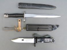 AKM type 2 bayonet in scabbard and a Swiss model 1957 bayonet with FW maker's mark to blade,
