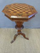 A Victorian mahogany games table with hinged lid and internal sewing compartments together with
