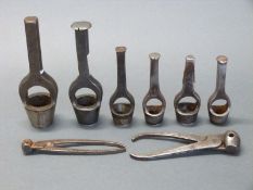 Six various wad punch tools together with two pairs of bullet moulds