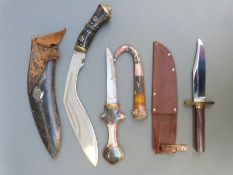 A kukri in leather scabbard with applied military badge, length 41cm,