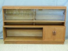 A retro G-Plan cabinet with sliding glass doors, cupboards and cubby holes,