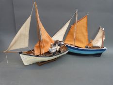 Two model clinker built sailing boats