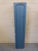 A metal gun safe / ammunition cabinet with keys