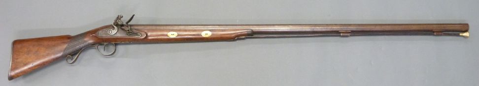 Hudson 4 bore flintlock hammer action gun with named and engraved lock, scrolling trigger guard,