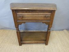 An oak canted table and 'Chevinette' card table and a swing frame mirror,