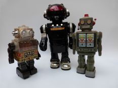 Three vintage battery operated robots including CODE 2003 AT-Z-X,