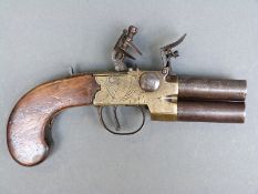 Indistinctly named 72 bore double barrelled over and under flintlock hammer tap action pistol with