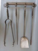 A set of blacksmith-made wrought iron fire irons