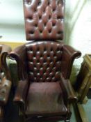 A red Chesterfield wing-back chair