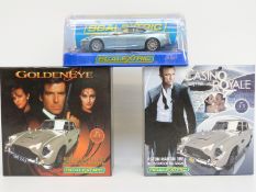 Three Scalextric James Bond Aston Martin cars, two limited edition from the Classic Collection,