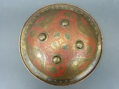 An Indian/ Persian 19thC dhal shield with finely engraved decoration and original velvet knuckle