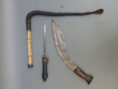 A kukri and an Eastern braided leather whip in mother in pearl and bone inlaid sheath,