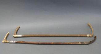 Two riding crops with silver collars,
