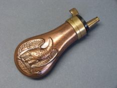 Copper and brass pistol powder flask with embossed decoration of an American style eagle holding a