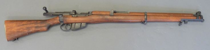 A replica rifle in the style of a Lee Enfield 303, with functioning action, overall length 111cm.
