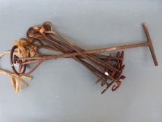 A collection of branding or marking irons