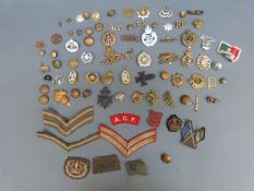 A quantity of British WWI and WWII cap badges, insignia etc including Royal Engineers, Naval,