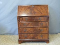 A reproduction mahogany bureau