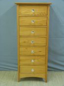 A tall pine chest of seven drawers with glass handles,