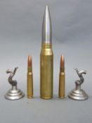 Five novelty paperweights one in the form of a 30mm cannon shell,