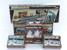 Seven Scalextric accessory sets comprising Twin Track Pitstop Set C190, Central Tower C702,