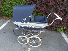 A Silver Cross pram together with two Pelham Puppets,