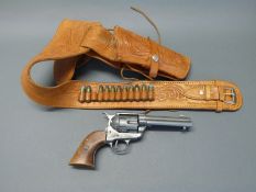 Six shot Colt replica revolver in embossed brown leather holster and belt with reproduction bullets