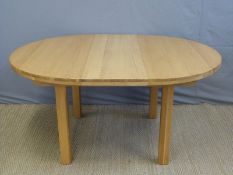 A modern light oak extending dining or kitchen table, diameter 120cm when retracted,