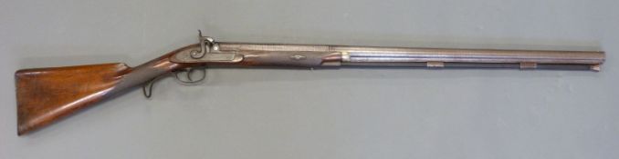 10 bore single barrelled percussion hammer action gun with engraved locks, stylised dolphin hammer,