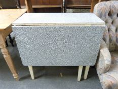 A retro 1950's Formica-topped fold-out table with cupboard and drawer,