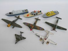 Eight Dinky Toys diecast model aeroplanes and boats, some military including Spitfire MKII,