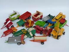 Twenty-two Britains and similar 1:32 scale diecast and plastic model agricultural vehicles
