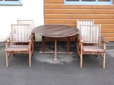 A teak garden set comprising table and four chairs,