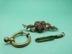 A jadeite charm in the form of a cricket bat,