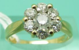 An 18ct gold ring set with round brilliant cut diamonds in a cluster,