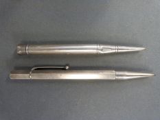 A hallmarked silver propelling pencil marked Baker's Perm - Point and a white metal example marked