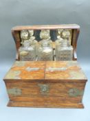 An oak three bottle tantalus with separated cigar and cigarette compartments and single drawer
