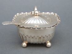A Victorian hallmarked silver mustard with blue glass liner, Sheffield 1889, maker Atkin brothers,