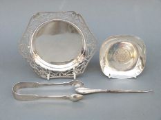 A pair of 19thC hallmarked silver sugar tongs and a coin-based tray marked 925, weight of both 110g,